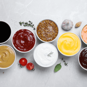 Condiments arranged with fresh herbs and garlic