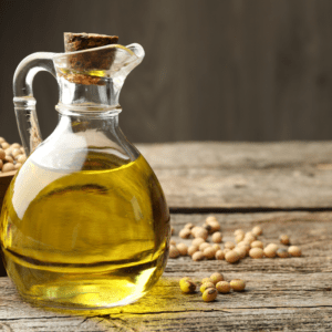 Rustic wooden table with oil and soybeans