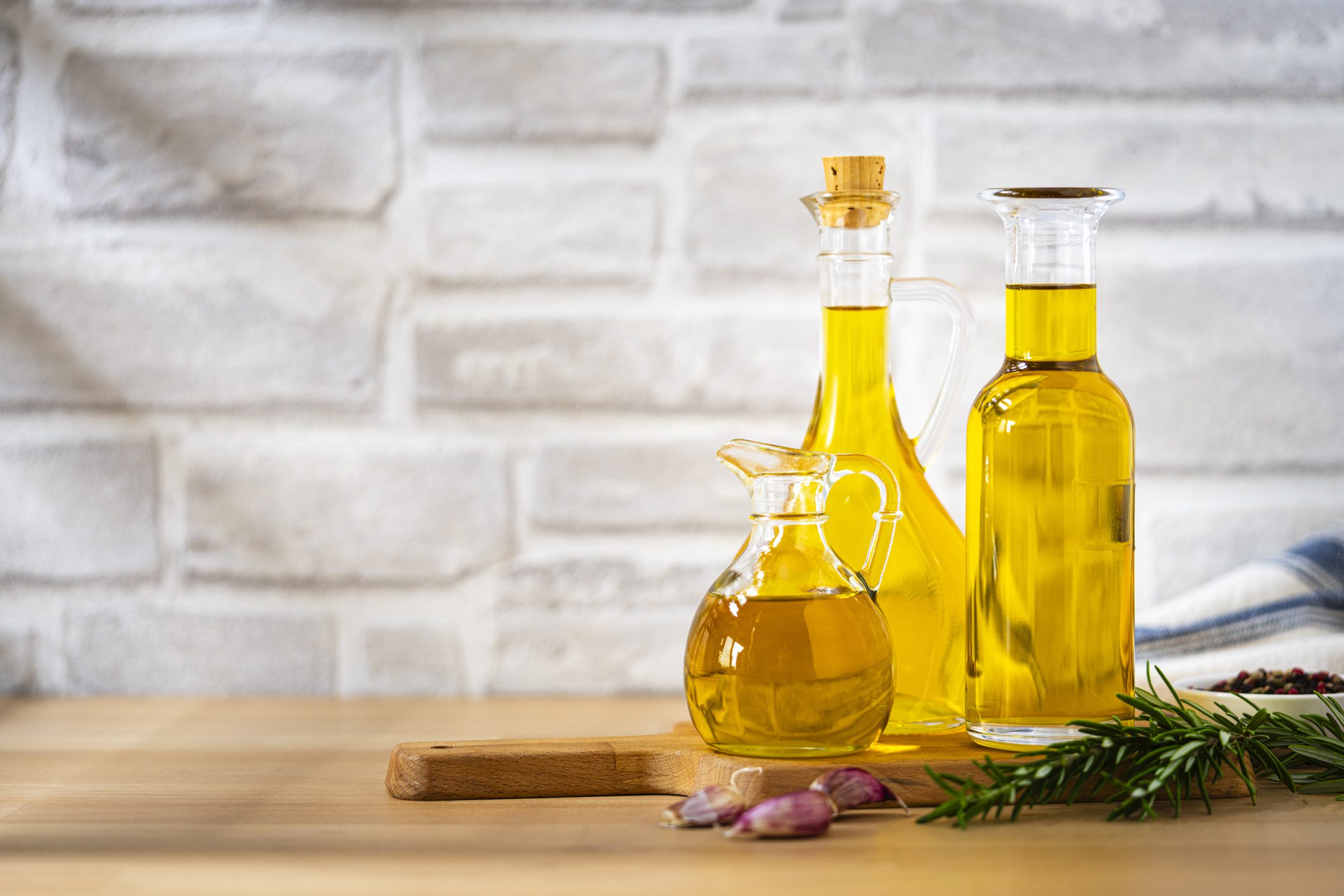 Olive oil bottles with rosemary and garlic